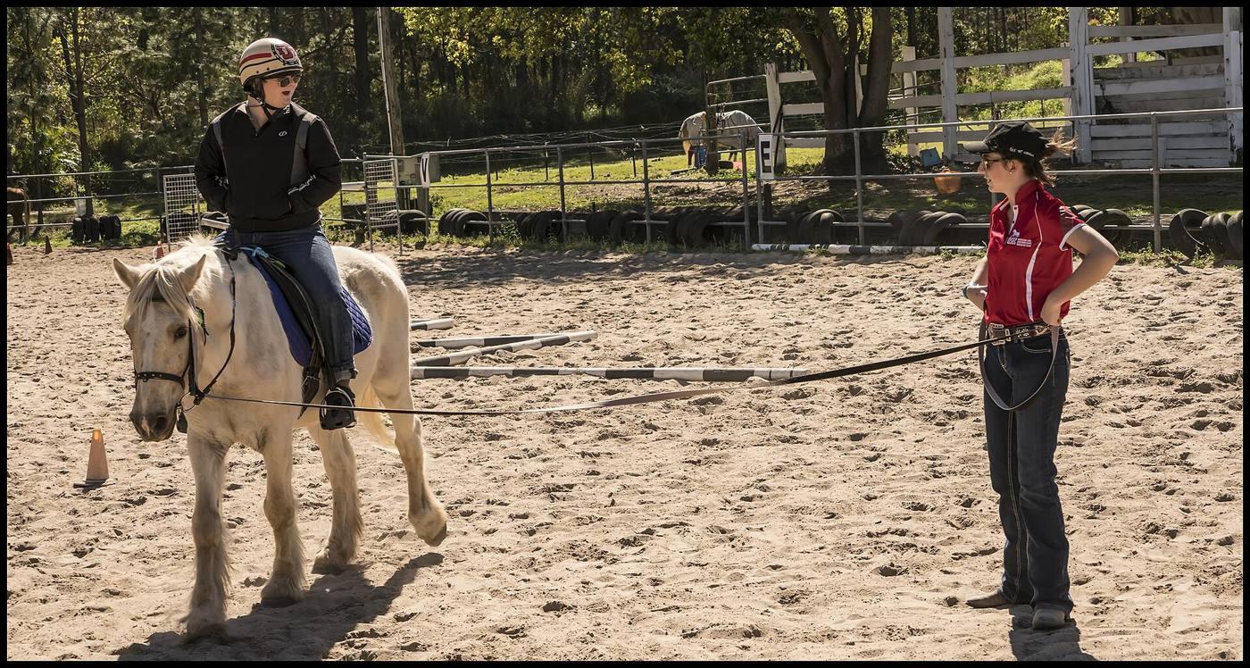 An instructor teaching a rider in the arena